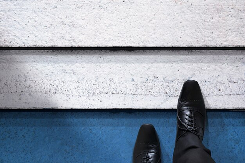 Feet in black shoes on stairs