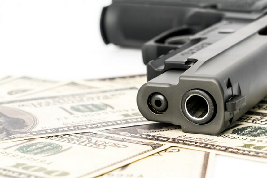 Gun and dollar bills
