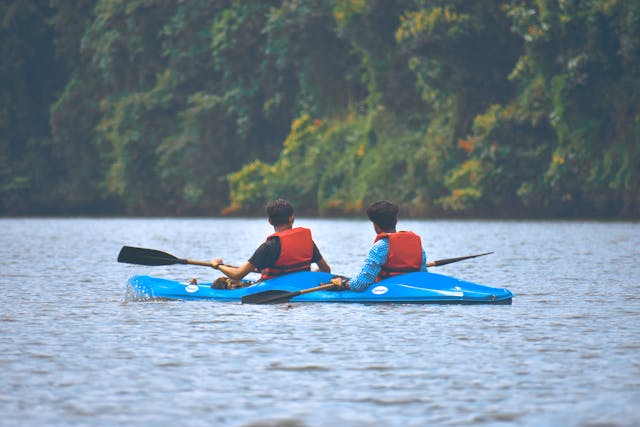 Two people kayaking on a serene lake